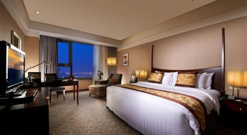 Bed in Grand New Century Hotel Binhai Tianjin