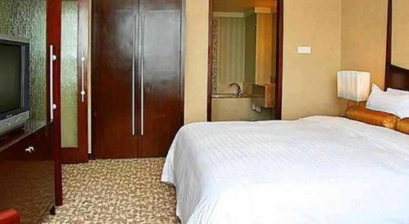 Bed in Grand New Century Hotel Binhai Tianjin