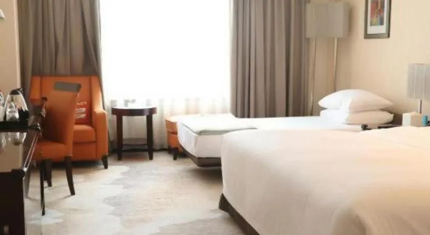 Bed in Grand New Century Hotel Binhai Tianjin