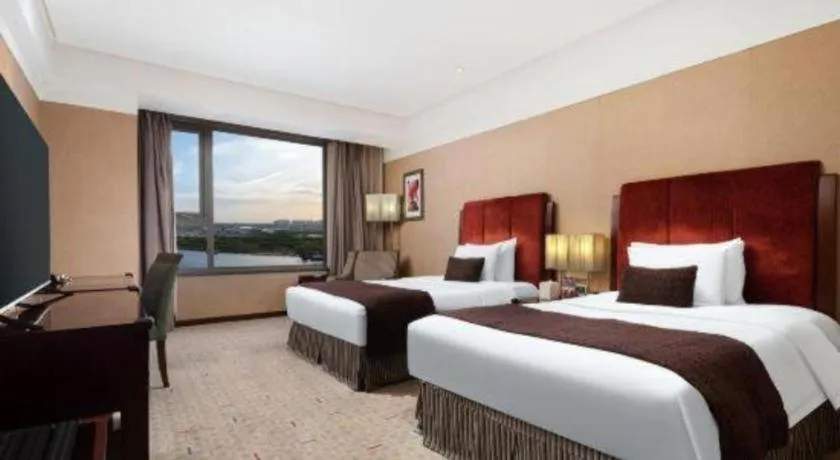 Bed in Grand New Century Hotel Binhai Tianjin