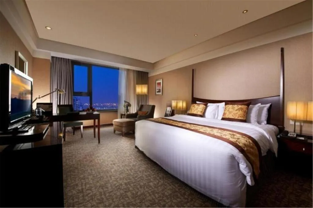 Bed in Grand New Century Hotel Binhai Tianjin