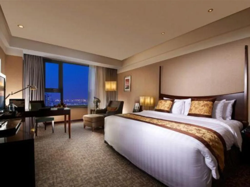Bed in Grand New Century Hotel Binhai Tianjin
