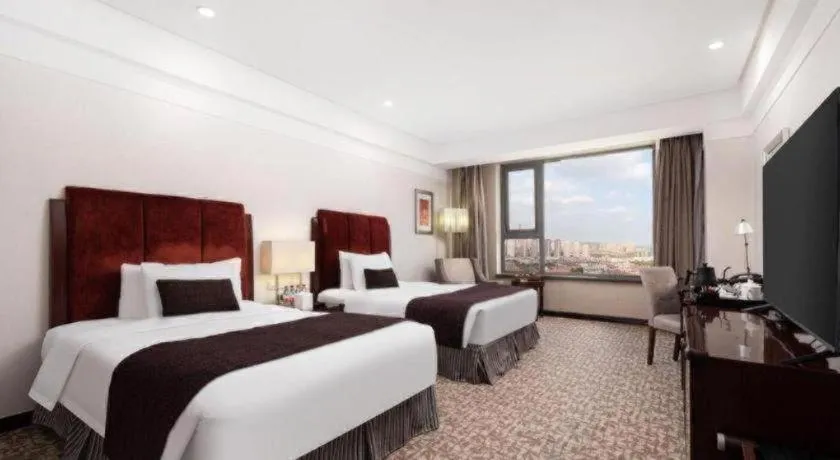 Bed in Grand New Century Hotel Binhai Tianjin