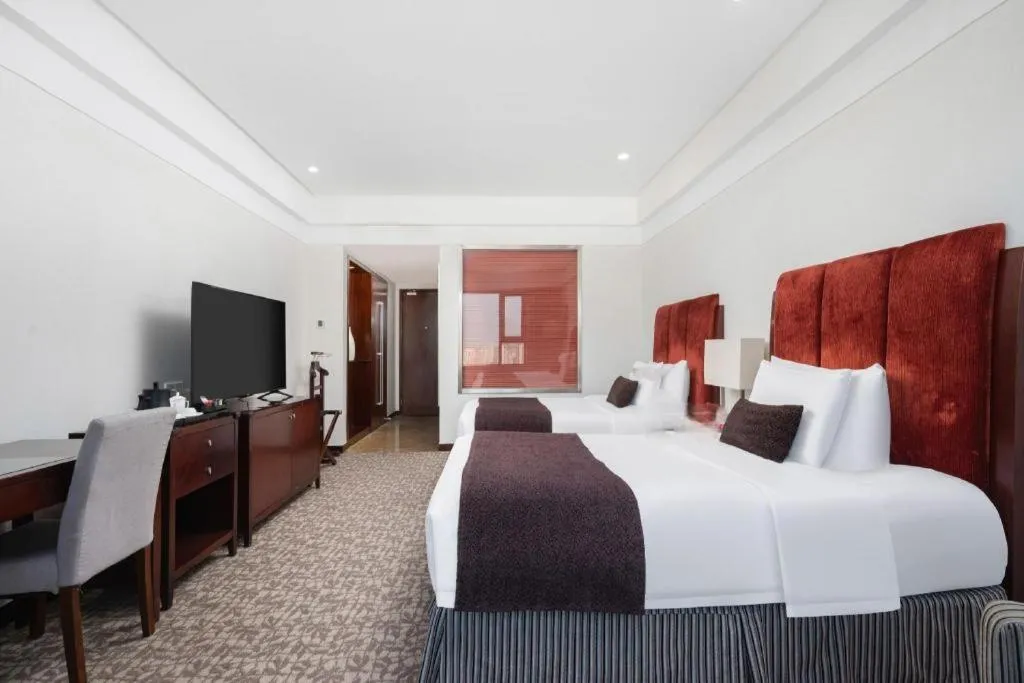 Bed in Grand New Century Hotel Binhai Tianjin