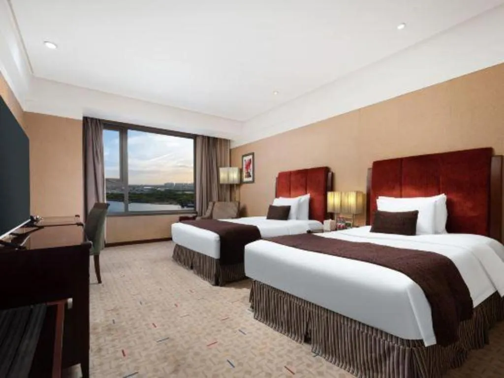 Bed in Grand New Century Hotel Binhai Tianjin
