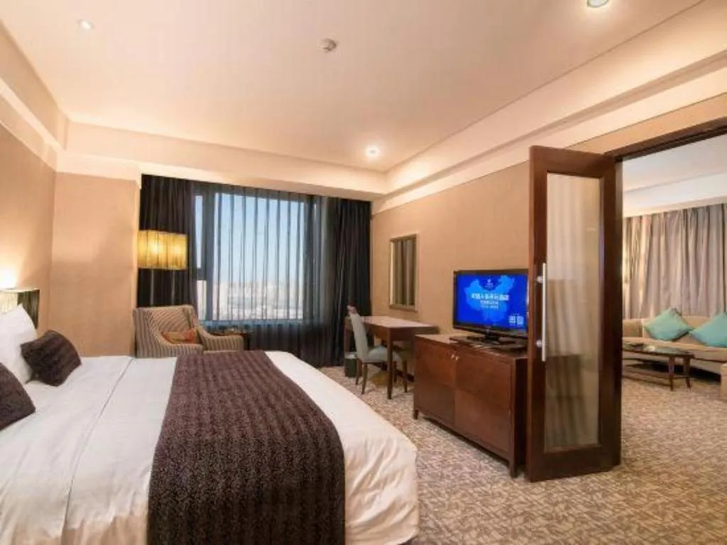 Bed in Grand New Century Hotel Binhai Tianjin