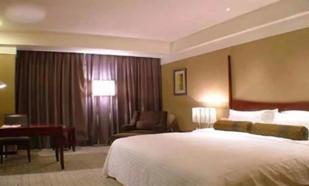 Bed in Grand New Century Hotel Binhai Tianjin