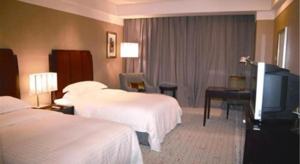 Bed in Grand New Century Hotel Binhai Tianjin