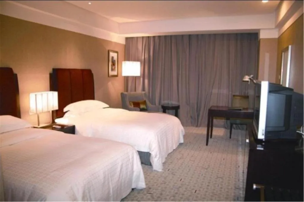 Bed in Grand New Century Hotel Binhai Tianjin