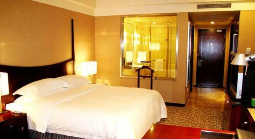 Bed in Grand New Century Hotel Binhai Tianjin