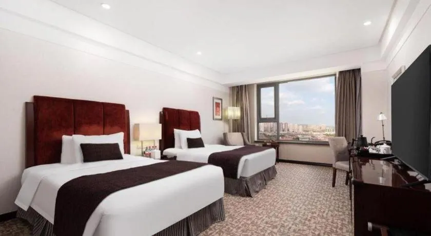 Bed in Grand New Century Hotel Binhai Tianjin