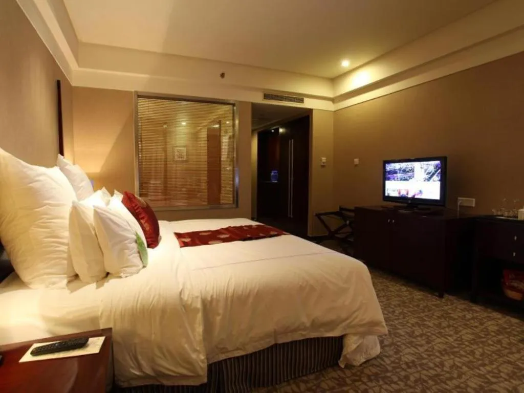 Bed in Grand New Century Hotel Binhai Tianjin