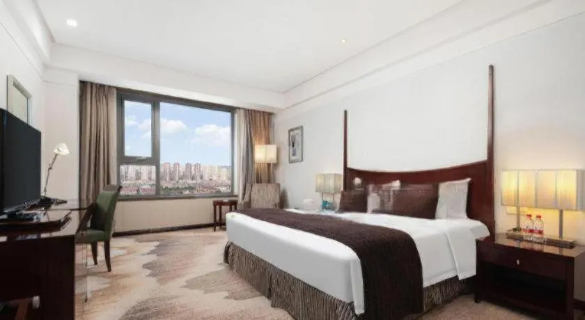 Bed in Grand New Century Hotel Binhai Tianjin