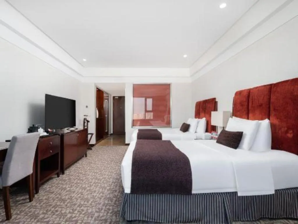 Bed in Grand New Century Hotel Binhai Tianjin