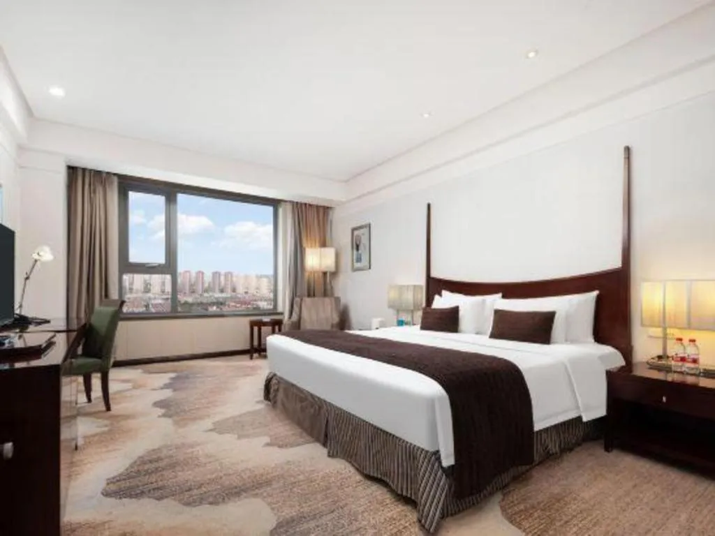 Bed in Grand New Century Hotel Binhai Tianjin