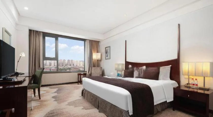 Bed in Grand New Century Hotel Binhai Tianjin