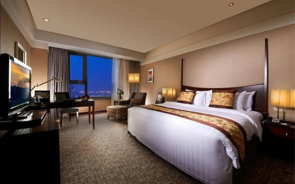 Bed in Grand New Century Hotel Binhai Tianjin