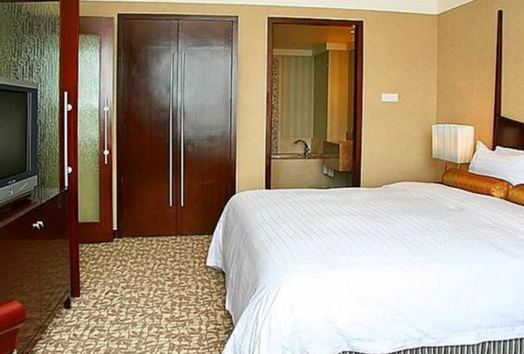 Bed in Grand New Century Hotel Binhai Tianjin