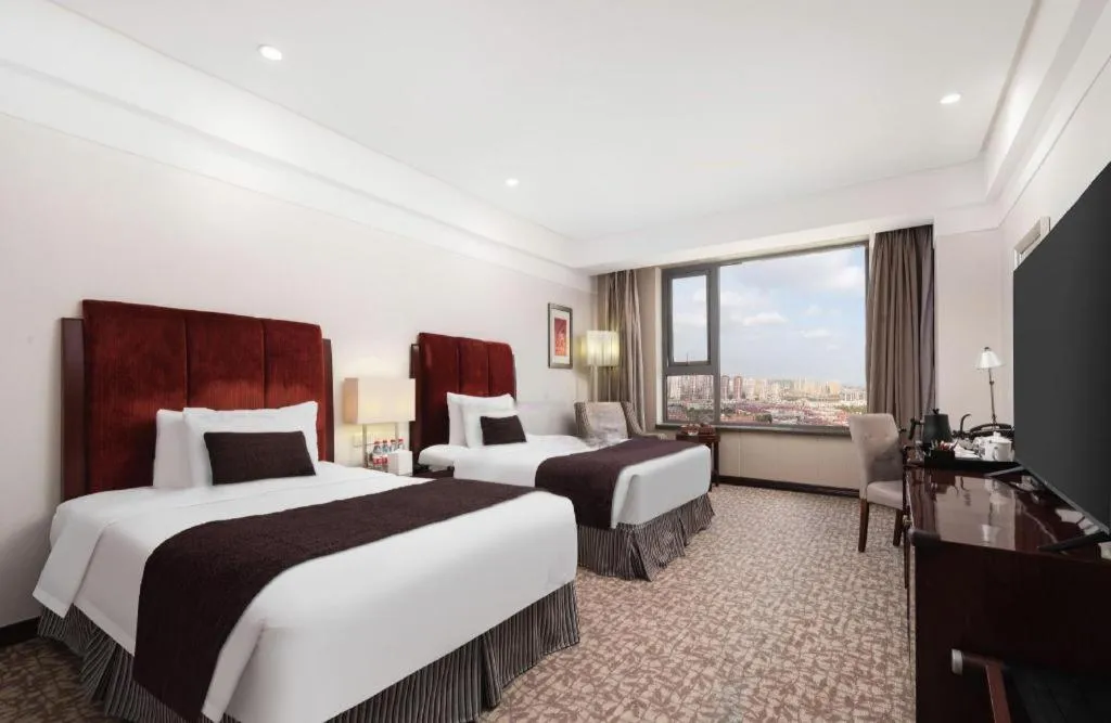 Bed in Grand New Century Hotel Binhai Tianjin