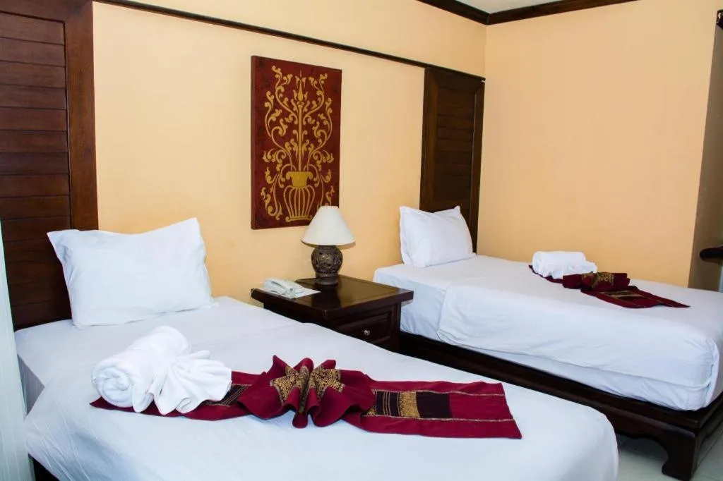 Bed in PhoomThai Garden Hotel