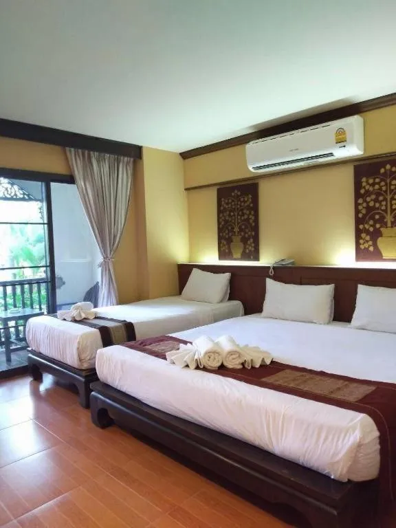 Bed in PhoomThai Garden Hotel
