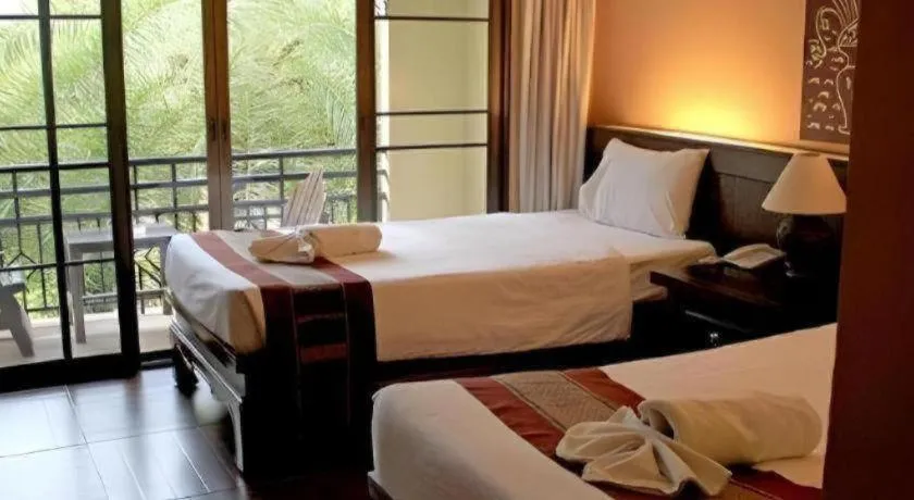 Bed in PhoomThai Garden Hotel