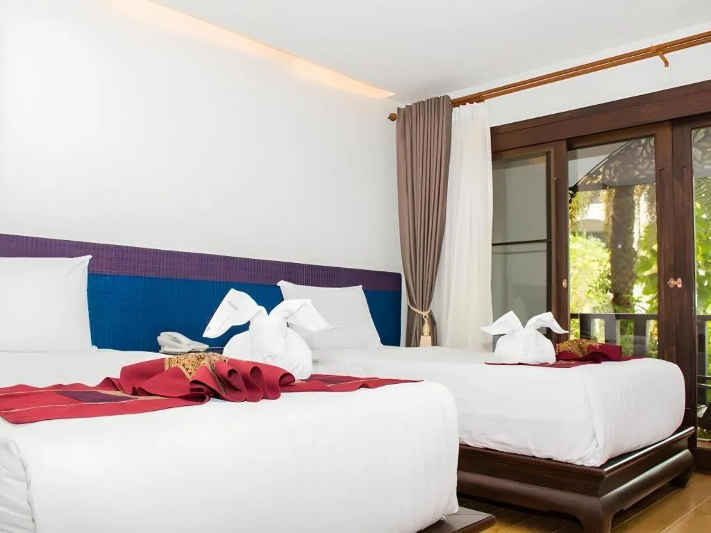 Bed in PhoomThai Garden Hotel