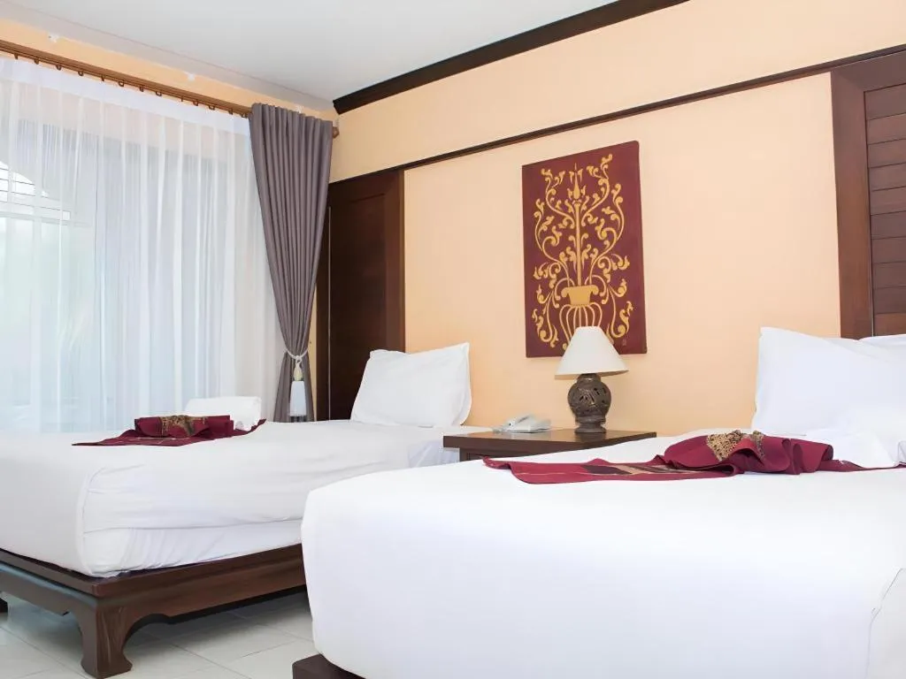Bed in PhoomThai Garden Hotel