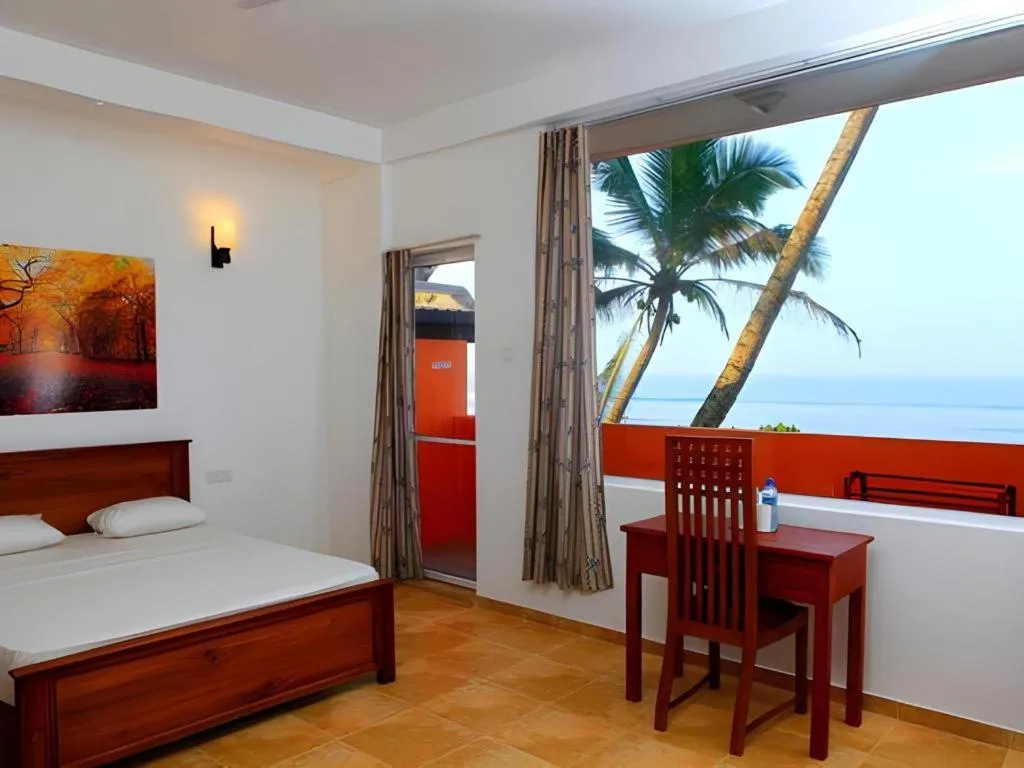 Bed in OYO 246 Roy Villa Beach Hotel