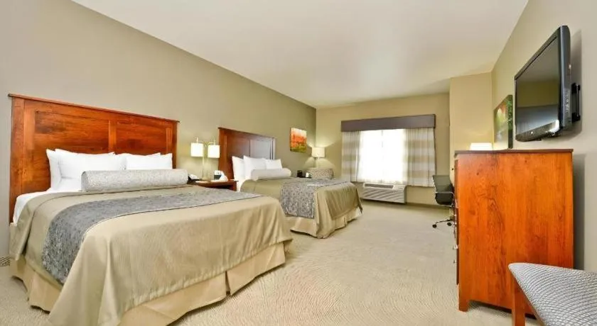 Bed in Green Mill Village Hotel & Suites, BW Signature Collection