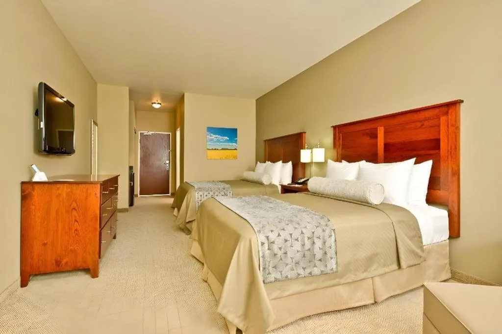 Bed in Green Mill Village Hotel & Suites, BW Signature Collection