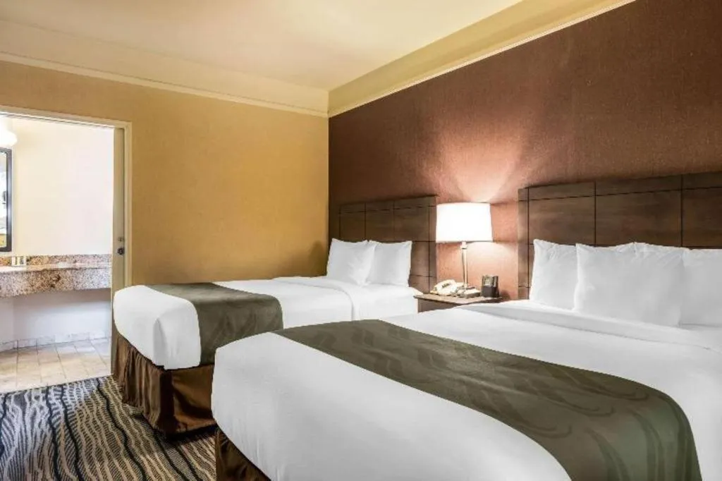 Bed in Ramada Suites by Wyndham San Diego