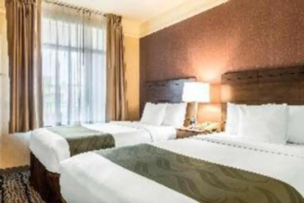 Bed in Ramada Suites by Wyndham San Diego