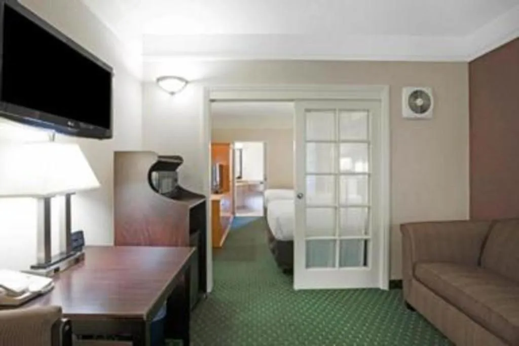 Bed in Ramada Suites by Wyndham San Diego