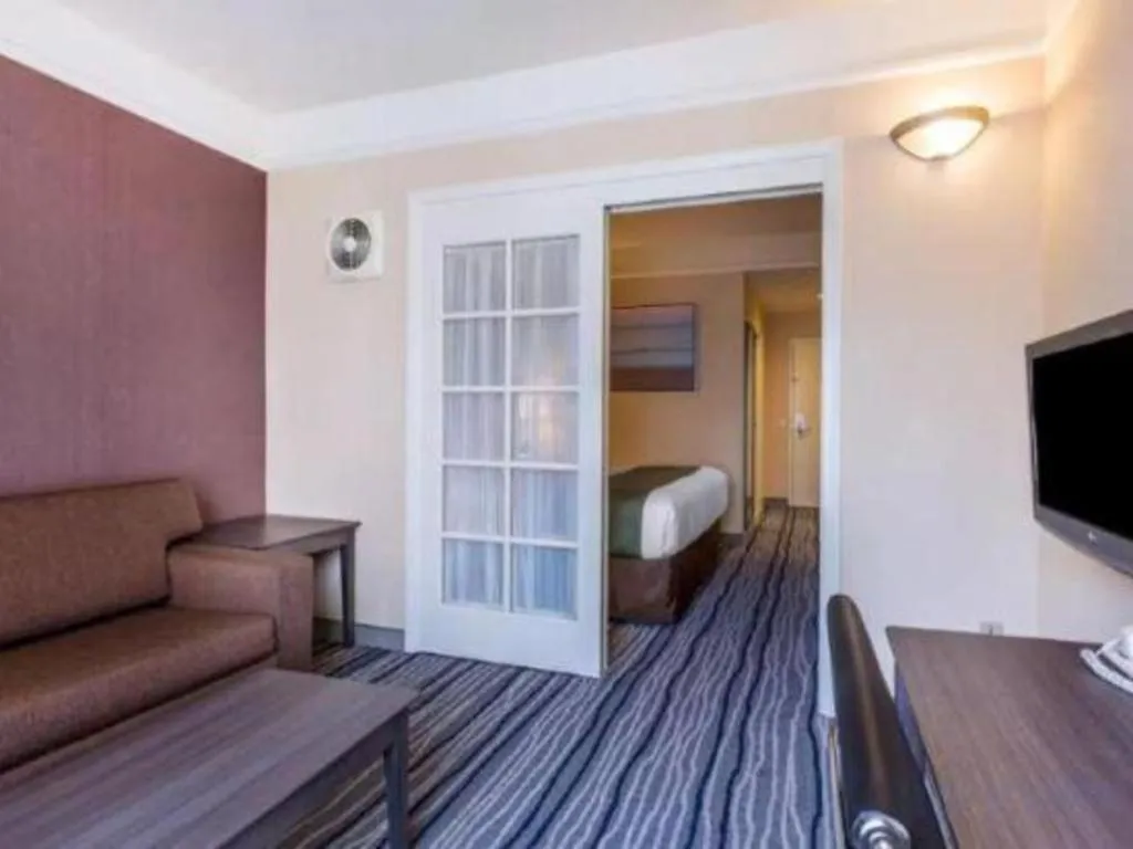 Bed in Ramada Suites by Wyndham San Diego