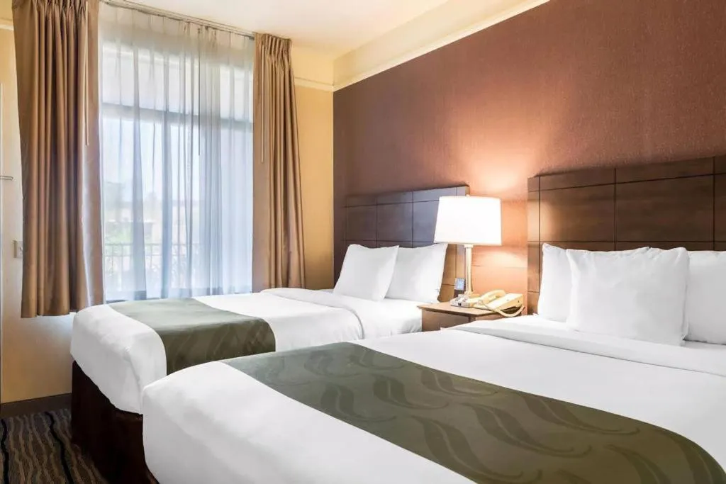 Bed in Ramada Suites by Wyndham San Diego