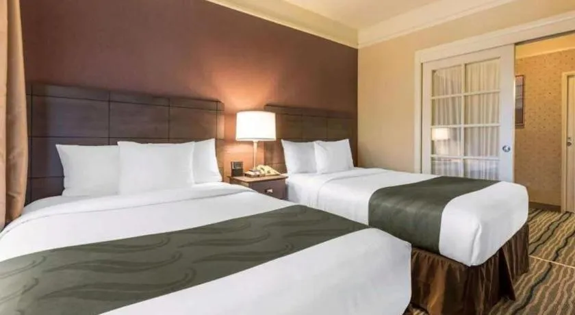 Bed in Ramada Suites by Wyndham San Diego