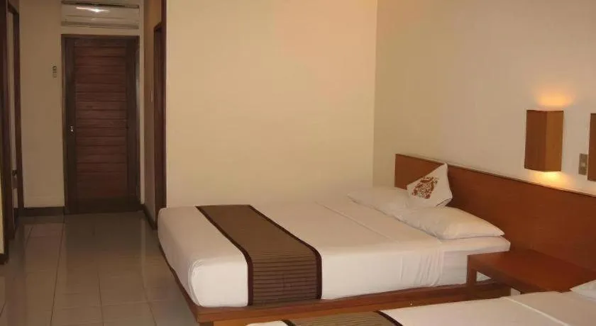 Bed in Nyiur Resort Hotel