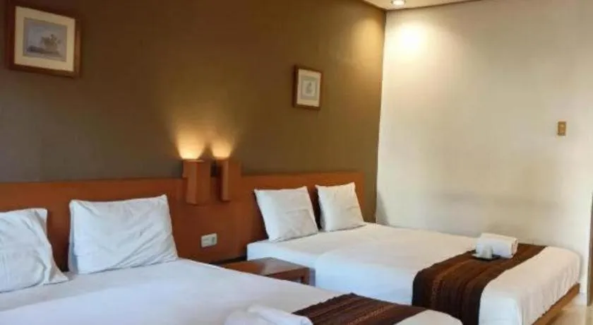 Bed in Nyiur Resort Hotel