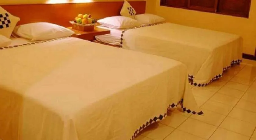 Bed in Nyiur Resort Hotel