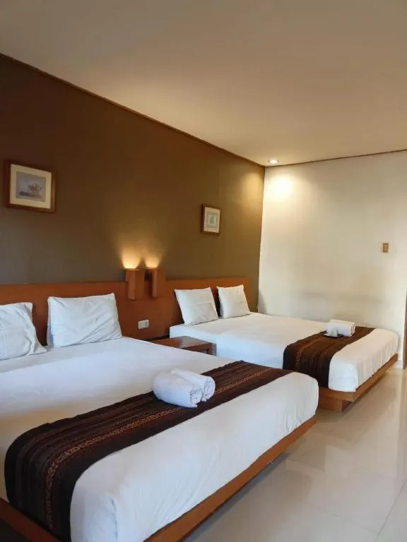 Bed in Nyiur Resort Hotel