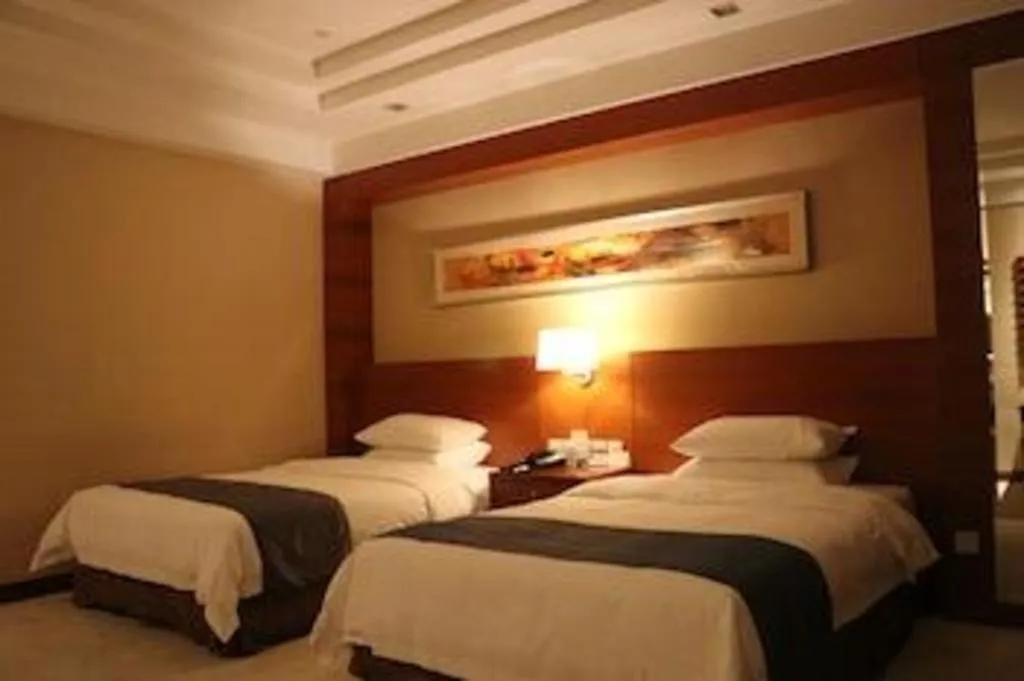 Bed in New Century Grand Hotel Ninghai Jinhai