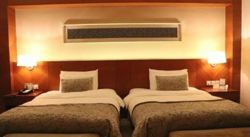 Bed in New Century Grand Hotel Ninghai Jinhai