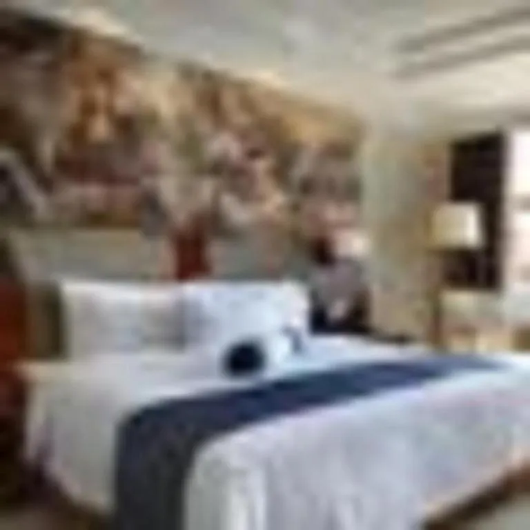 Bed in New Century Grand Hotel Ninghai Jinhai