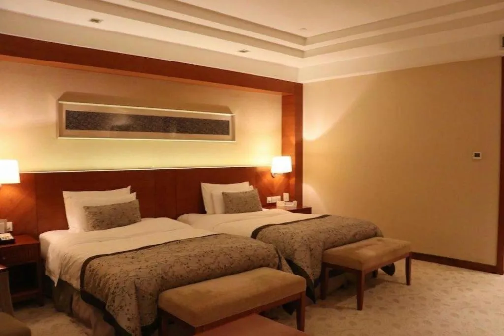 Bed in New Century Grand Hotel Ninghai Jinhai