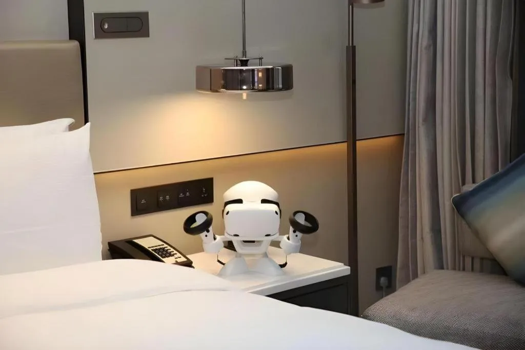 Bed in New Century Grand Hotel Hangzhou Fuyang Dongfangmao