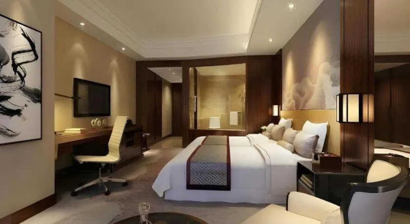 Bed in New Century Grand Hotel Hangzhou Fuyang Dongfangmao