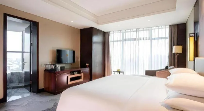 Bed in New Century Grand Hotel Hangzhou Fuyang Dongfangmao