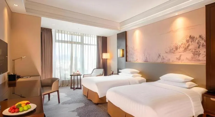 Bed in New Century Grand Hotel Hangzhou Fuyang Dongfangmao