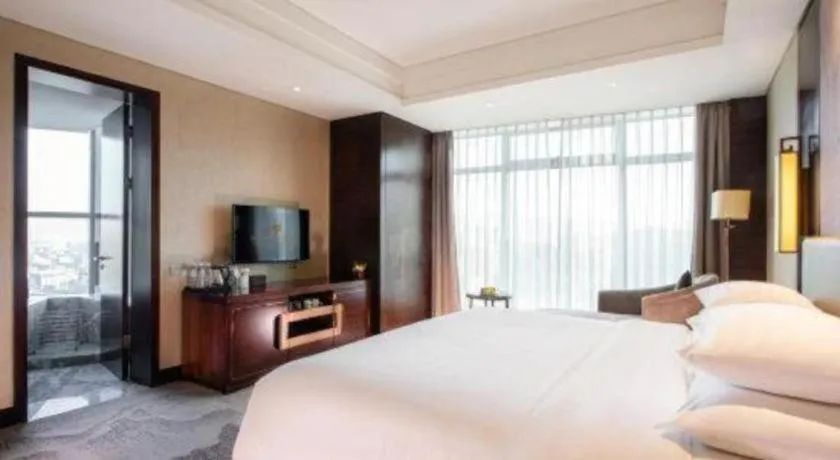 Bed in New Century Grand Hotel Hangzhou Fuyang Dongfangmao